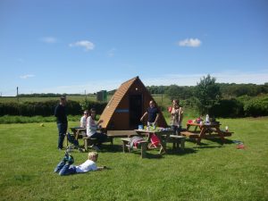 Family outside wigwam